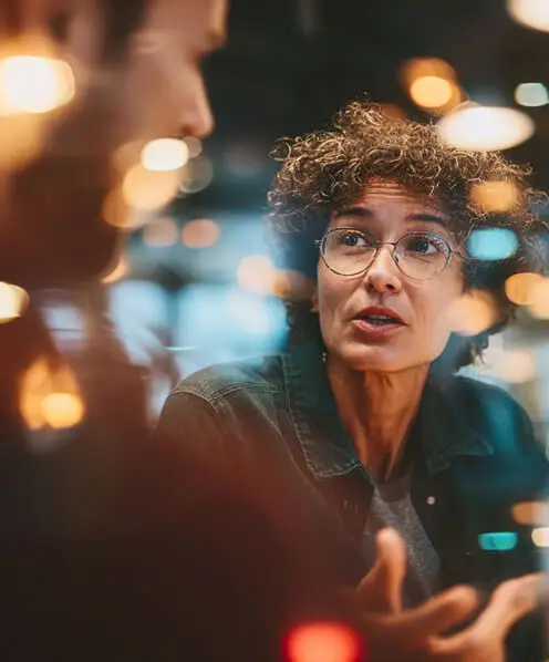 Two people discussing ideas in a modern office