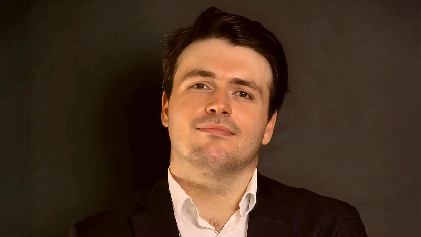 Man in suit smiling confidently